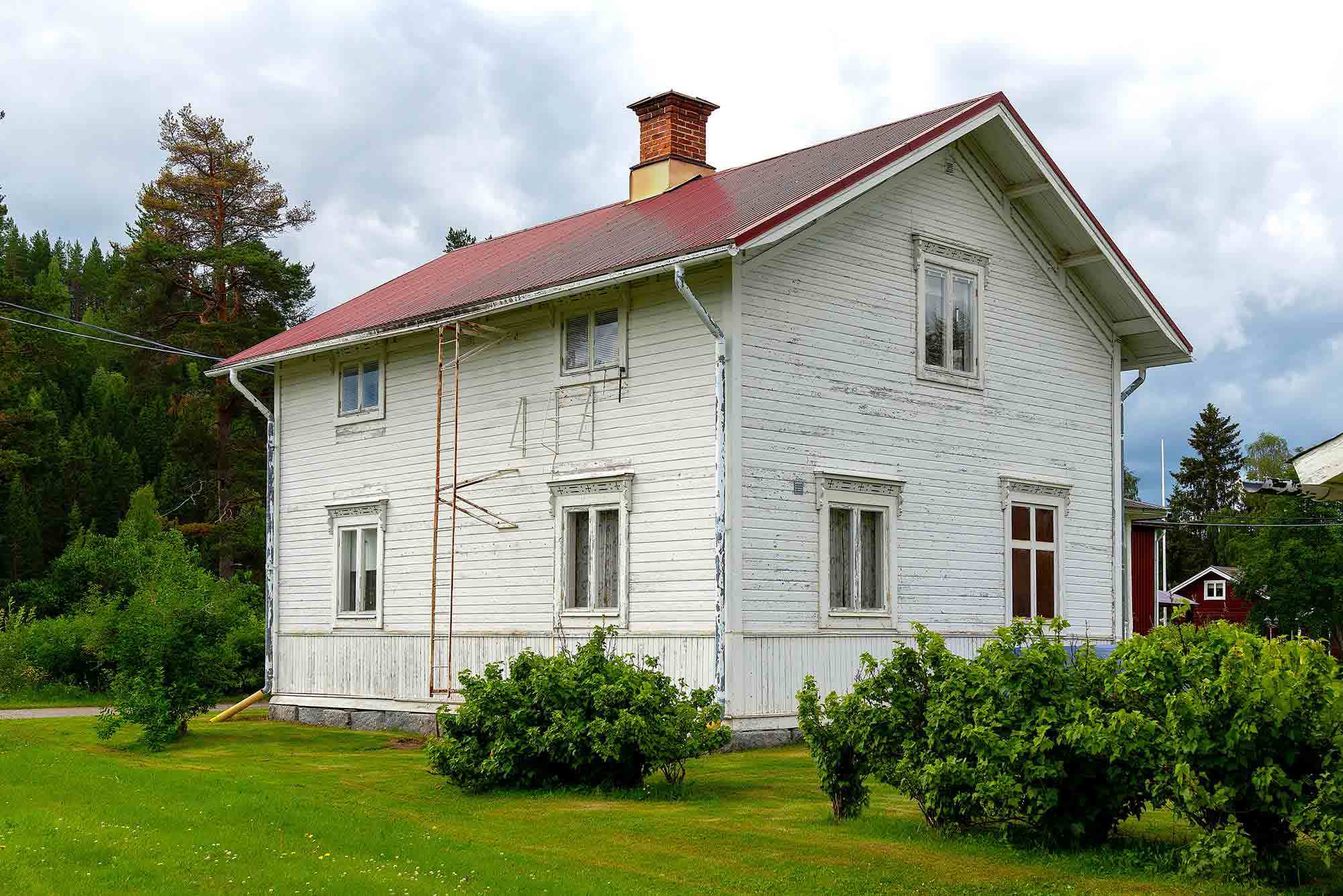 Vitt hus med visst renoveringsbehov