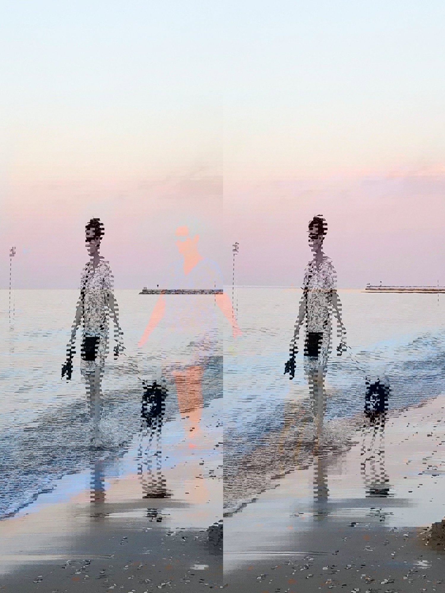 Lisa och luna, en kvinna och en hund som går längs vattnet