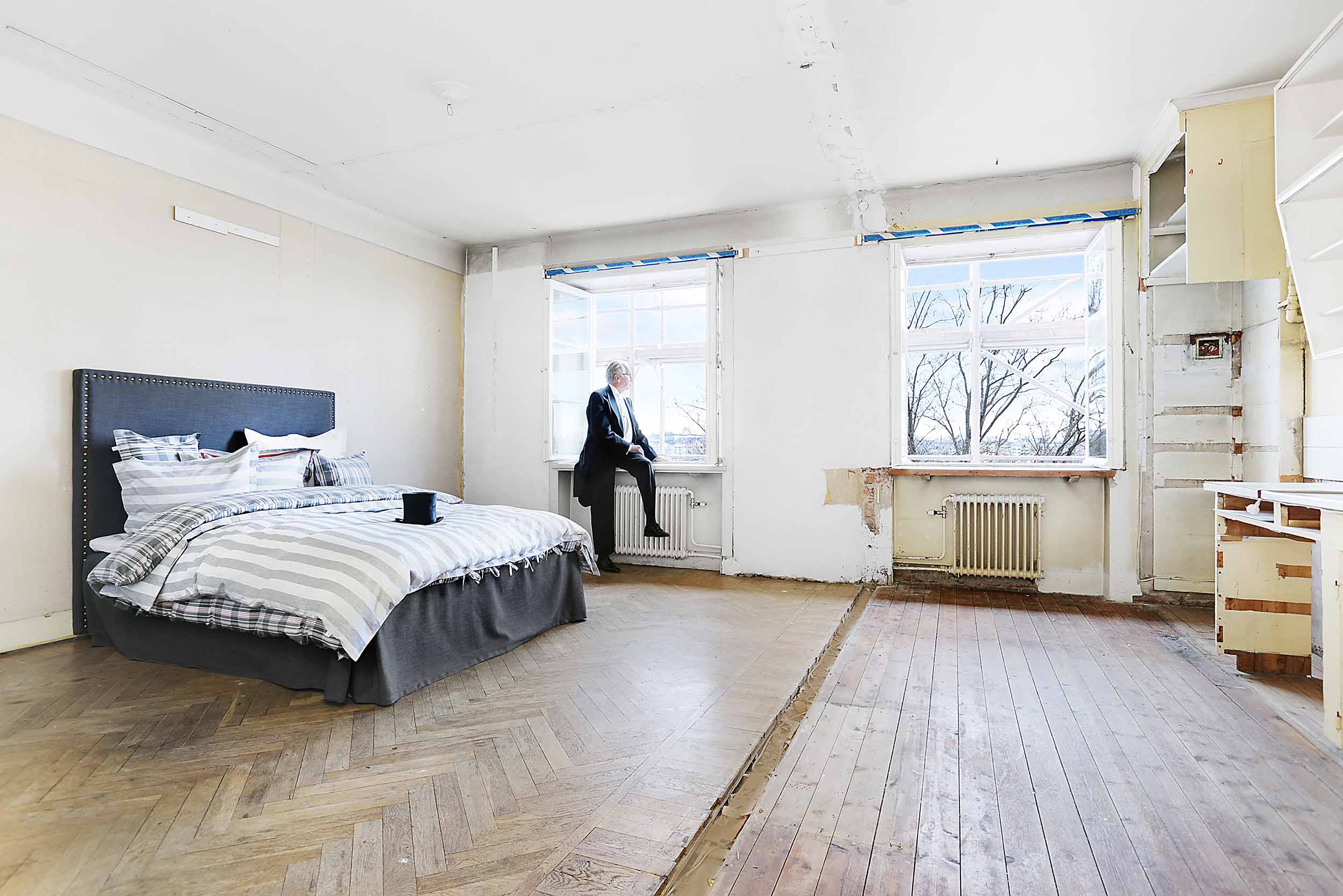 Bo Lingserius poserandes med frack i fönster på bostad